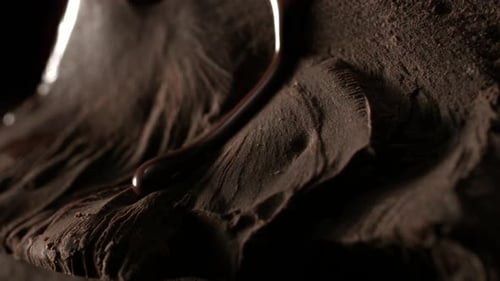 Liquid Chocolate Pouring Over Chocolate Shavings