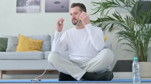Man Listening Music on Headphones and Meditating