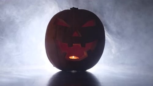 Illuminated Jack O'Lantern in Smoky Dark Setting