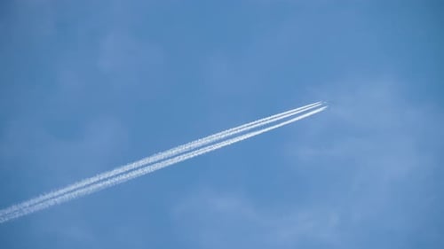 Airplane Flying Through the Clear Blue Sky