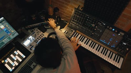 Musician Creating Music in Dark Studio
