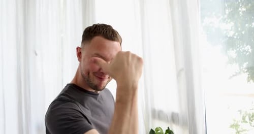 Man Gives Thumbs Up Gesture Indoors