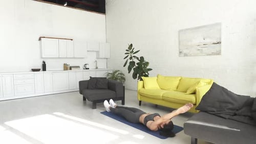 Athletic Woman Doing Ab Exercises at Home