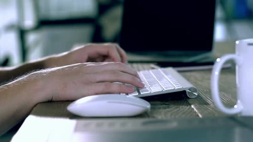 A Caucasian Male Typing on a Wireless Keyboard 20