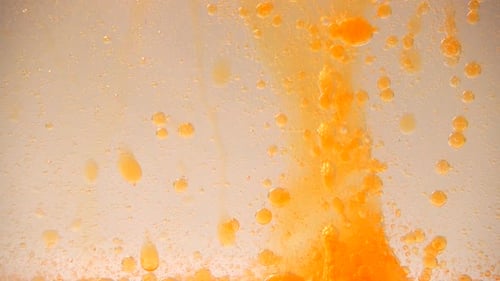 Abstract Orange Liquid and Bubbles Flowing Down