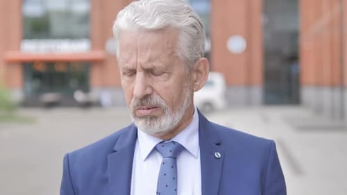 Senior Man in Suit Coughing Outdoors