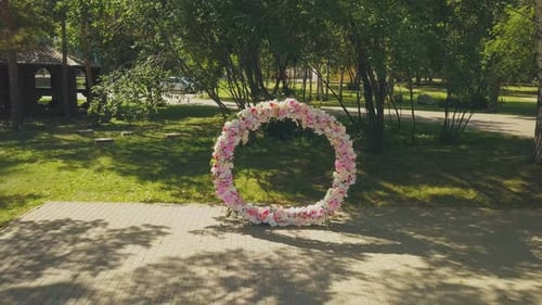 Nice Wedding Venue with Flowers and Chairs in Park Aerial