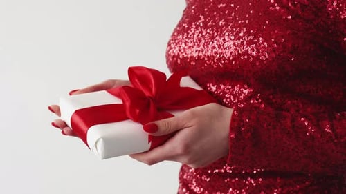 Woman in Red Holds Wrapped Birthday Gift
