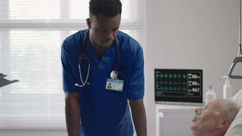 Senior Patient on Bed Talking to 2 African American Doctor in Hospital Room Health Care and
