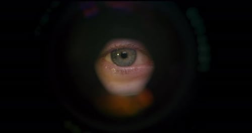 Close-up Shot. Shooting From the Middle. The Eye Is Looking Through a Microscope.