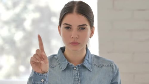 Young Woman Shakes Finger to Disagree
