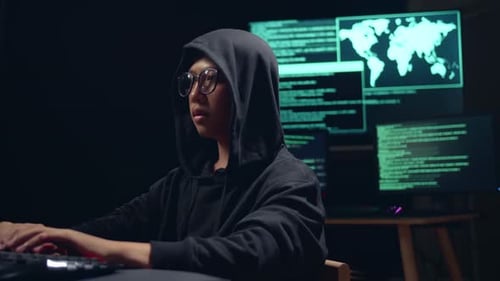 Asian Boy Hacker Using Computer Hacking