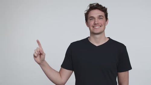 Smiling Man Points Up to the Right