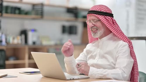 Senior Man Video Conferencing on Laptop Computer