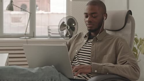African-American Programmer Working on Laptop in Office