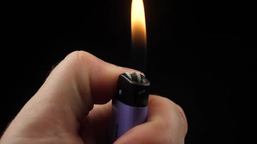 Slow Motion Video of Using a Lighter at Night with Sparkles and Fire