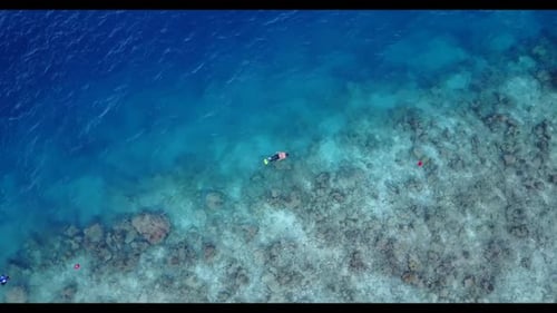 Boy and girl happy together on perfect coastline beach vacation by blue ocean and white sandy backgr