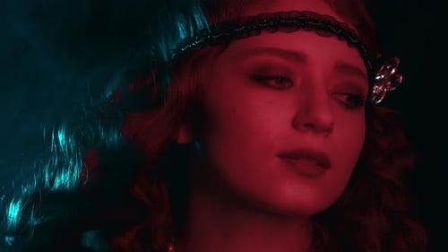 Portrait of Woman Dressed in Style of Great Gatsby Flirting and Posing on Dark