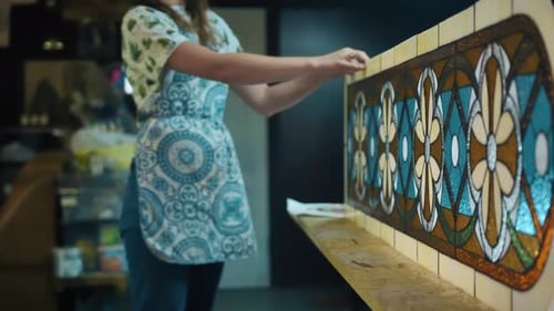 Two Female Artists in the Stained Glass Workshop are Completing the Production of the Stained Glass