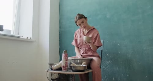 Young Woman Shaping Clay Bowl in Bright Studio