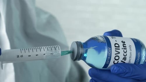 Drawing Covid-19 Vaccine into Syringe from Vial