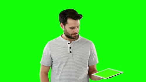 Young Adult Man Uses Tablet Device Green Screen