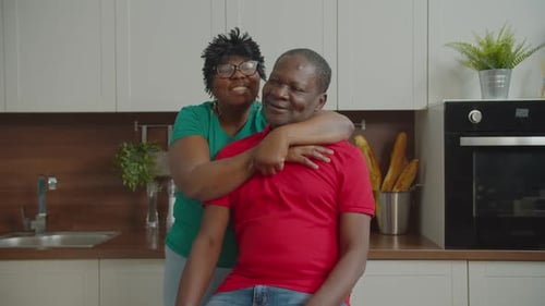 Affectionate Couple Embracing in Bright Kitchen