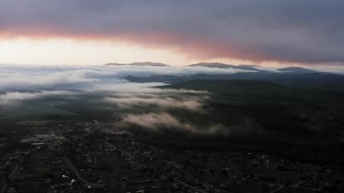 Aerial Drone Sunrise View Over Foggy Countryside with Wooden Houses