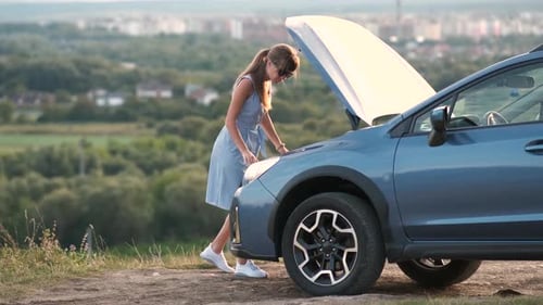 Young Woman Driver Standing Near a Broken Car with Open Hood Having Trouble with Her Vehicle