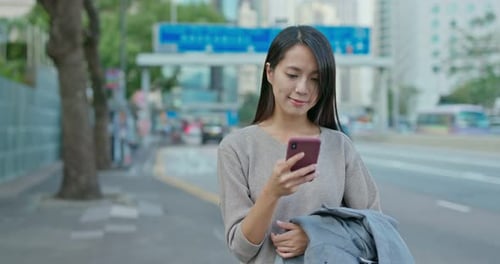 Woman use of mobile phone in city