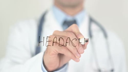 Doctor Writing Headache with a Marker
