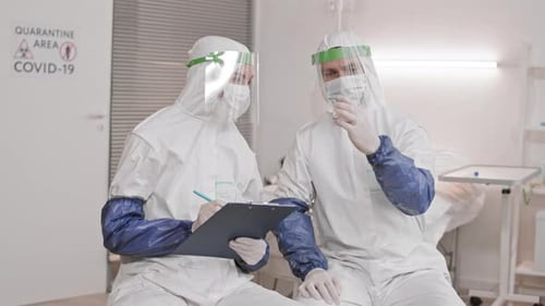 Medical Researchers Inspect Vial in Hospital Setting