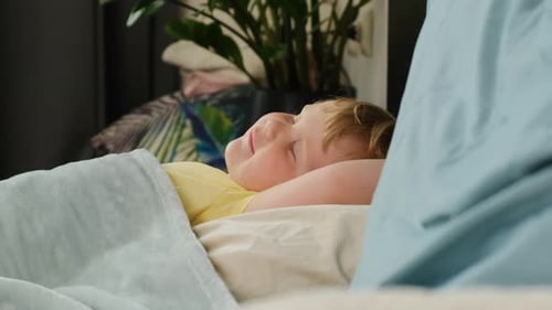 Child Waking Up From a Nap in Bed
