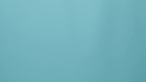 Used Surgical Masks Falling on Blue Surface