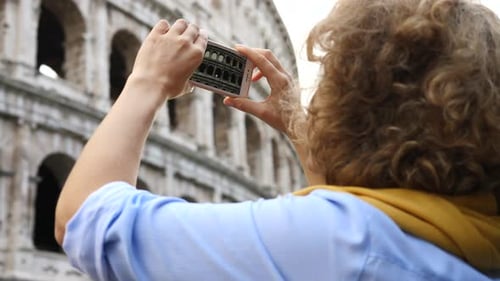 Woman Takes Pictures of Colosseum with her Phone