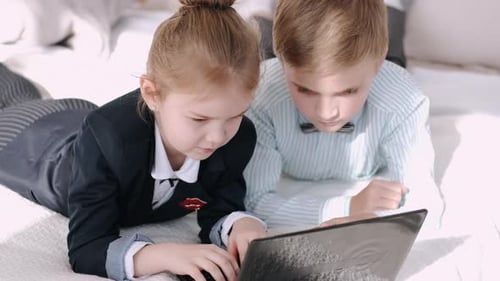 Kids of Primary School Are Studying Online at Home During Quarantine