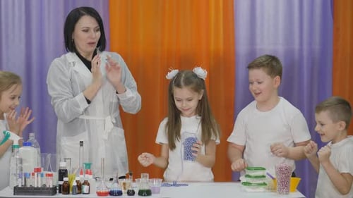 Enthusiastic Children Conduct Science Experiment with Teacher