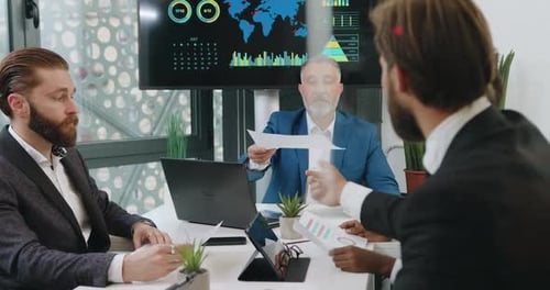 Business Meeting in Modern Office with Data Charts