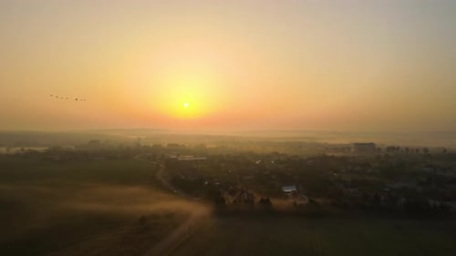 Aerial View Foggy Sunrise Over Residential Houses in Suburban Rural Area