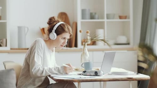 Young Woman Working from Home on Computer