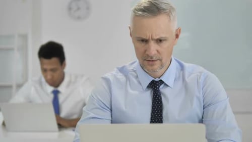 Businessman Frustrated at Computer in Modern Office
