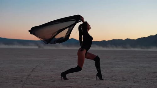 Elegant Woman Posing in Desert at Sunrise