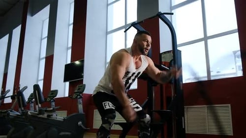 Fitness Man Doing an Intense Workout Using Ropes in a Gym
