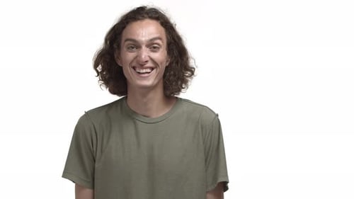 Handsome Caucasian Guy in Casual Tshirt Laughing and Smiling Looking Happy at Camera Standing Over