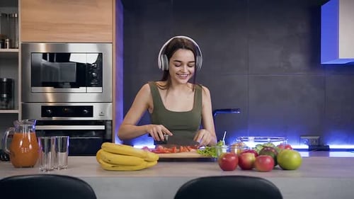 Smiling Woman Cooking Food in Modern Kitchen