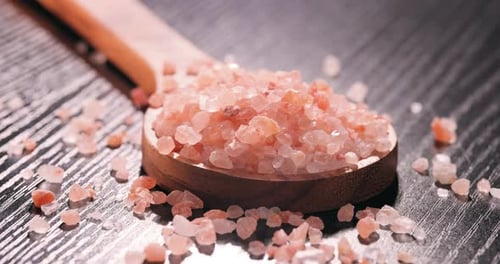 Pink Himalayan Salt Crystals in a Wooden Spoon