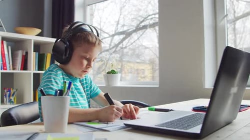 Focused Child Drawing with Headphones On
