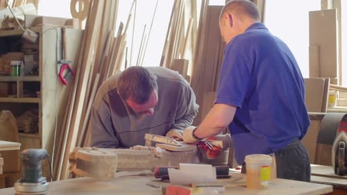 Men Working on Woodworking Project in Workshop