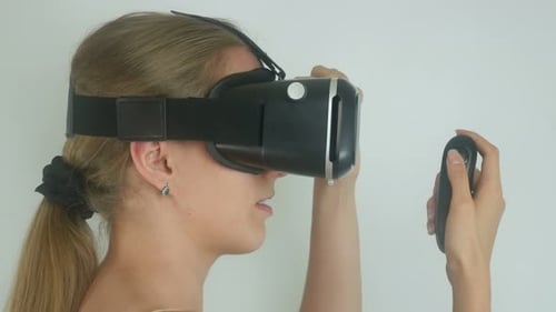Blonde Woman Wearing VR Headset Using Remote