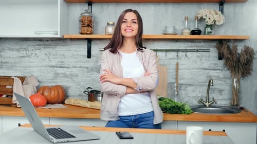 Woman Smiling in Bright Kitchen with Ingredients